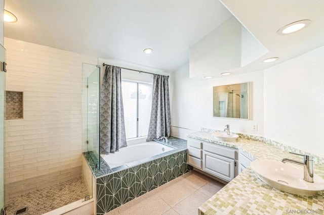 bathroom featuring tile patterned floors, independent shower and bath, and vanity