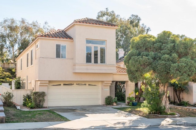 mediterranean / spanish-style home with a garage