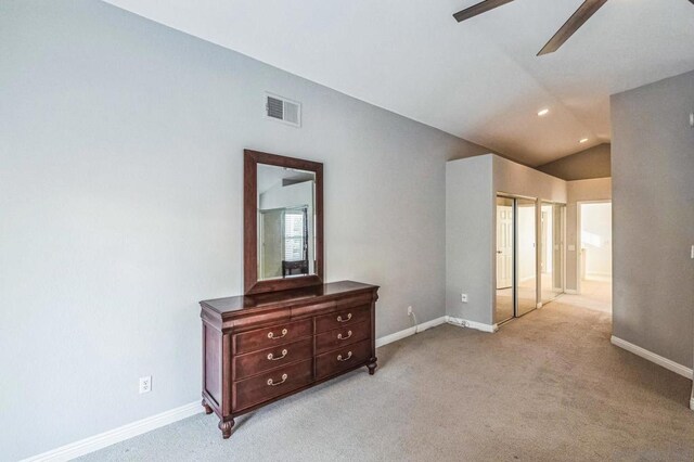 carpeted spare room with lofted ceiling and ceiling fan