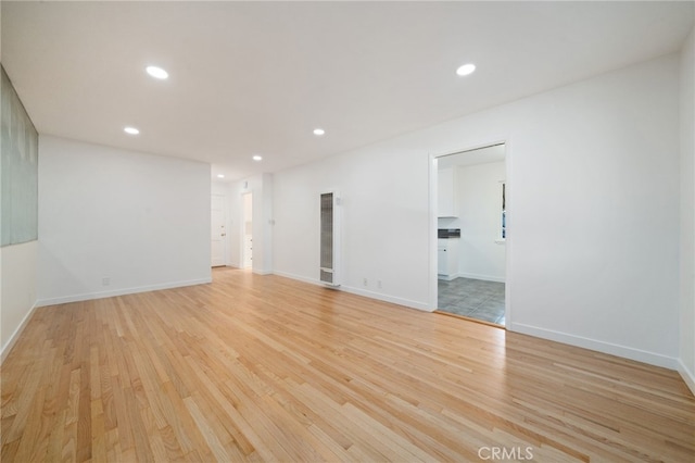734 Linden Ave Unit 7, Long Beach, CA 90813 - spare room featuring a heating unit, light wood-type flooring, and recessed lighting