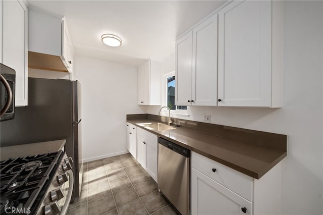 734 Linden Ave Unit 7, Long Beach, CA 90813 - kitchen featuring appliances with stainless steel finishes, dark countertops, white cabinetry, and tile patterned flooring