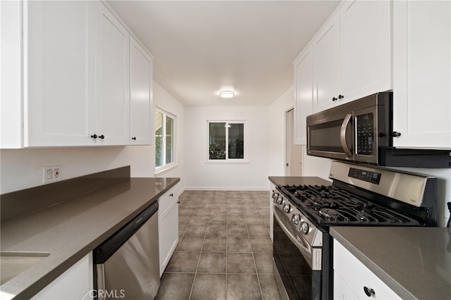 734 Linden Ave Unit 7, Long Beach, CA 90813 - kitchen with stainless steel appliances, dark countertops, white cabinets, and tile patterned flooring