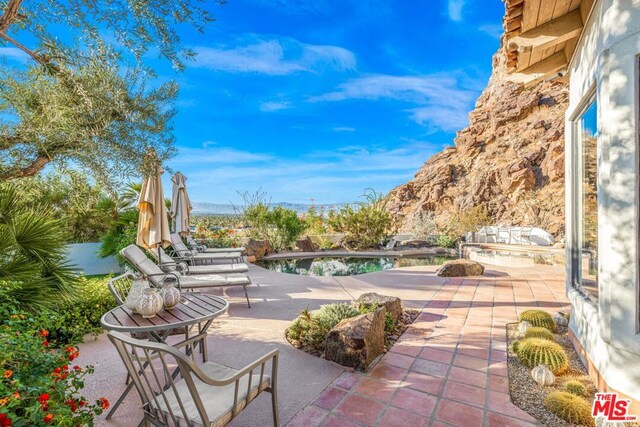 view of patio / terrace featuring a mountain view