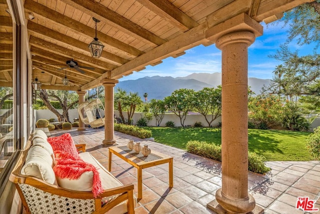 view of patio with a mountain view and ceiling fan