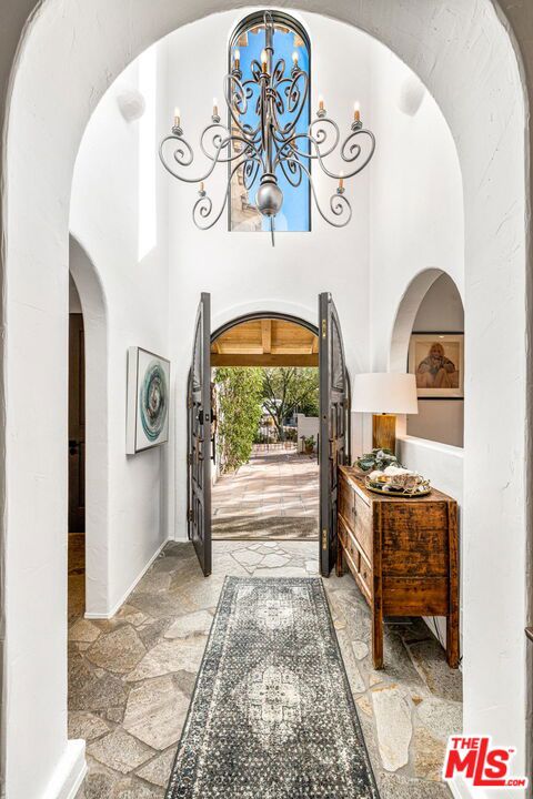 entrance foyer with a notable chandelier and a towering ceiling