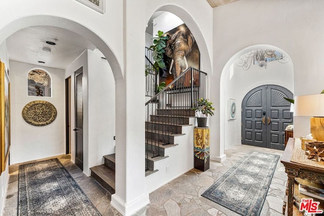 foyer entrance with a towering ceiling