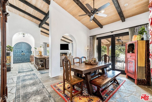 dining room with high vaulted ceiling, wooden ceiling, beam ceiling, and french doors