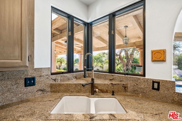 room details featuring stone countertops and sink