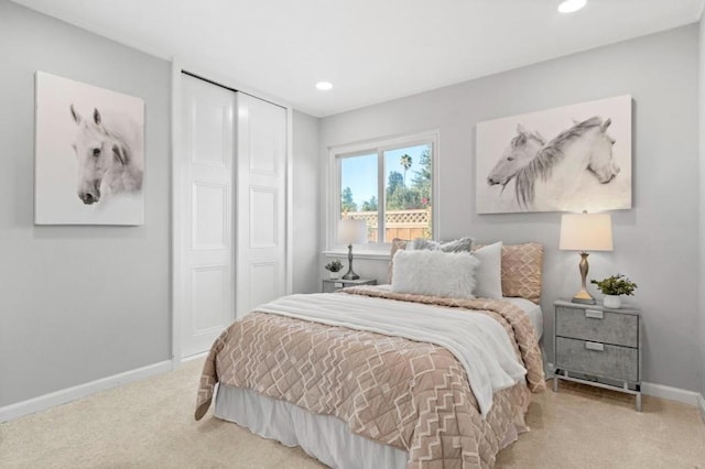 bedroom with light carpet and a closet