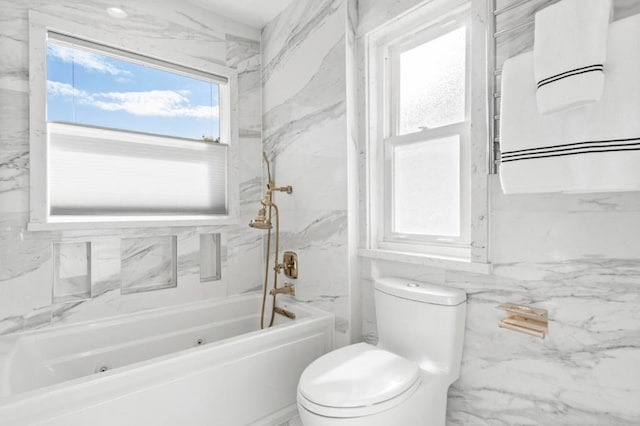 bathroom with tiled shower / bath and toilet