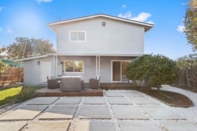 back of house with outdoor lounge area and a patio