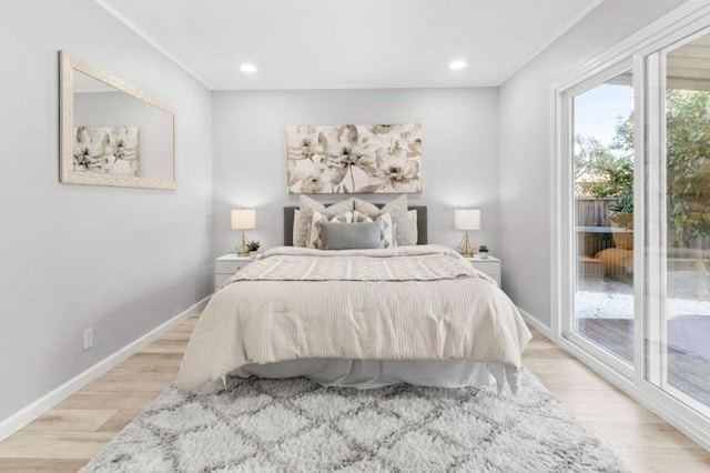 bedroom featuring access to exterior and light wood-type flooring