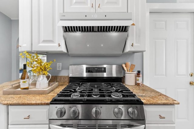 kitchen with white cabinetry, light stone countertops, stainless steel gas range, and range hood