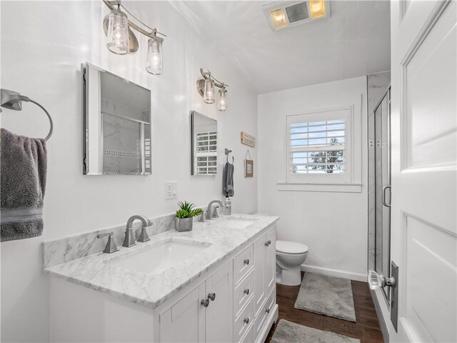 bathroom featuring an enclosed shower, vanity, and toilet