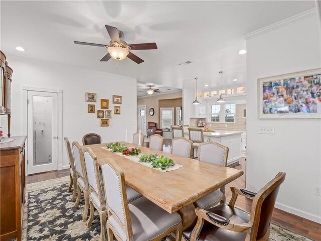 dining area featuring crown molding and light hardwood / wood-style floors