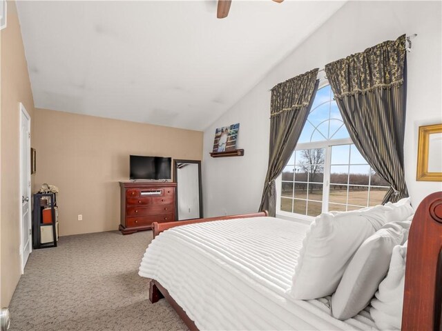 bedroom featuring ceiling fan, lofted ceiling, and carpet floors