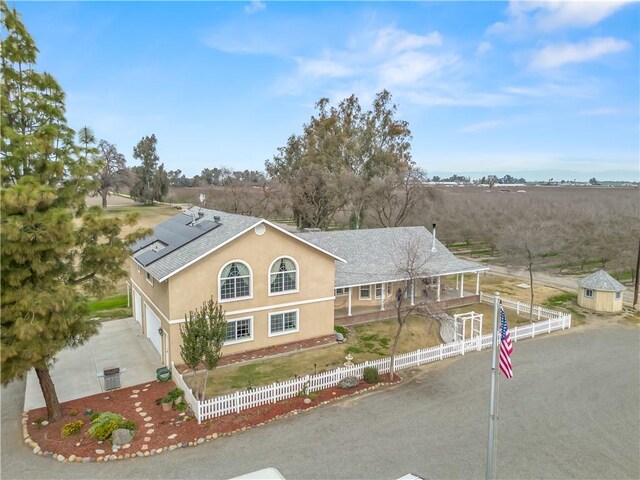 view of front of property featuring a garage and solar panels