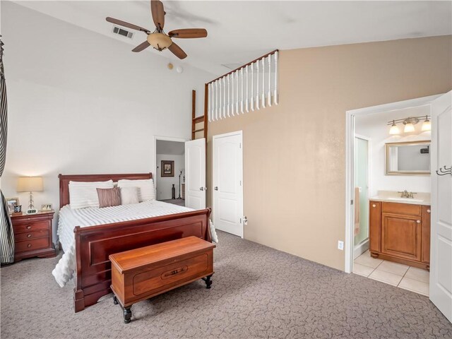 carpeted bedroom featuring sink, ceiling fan, and ensuite bathroom