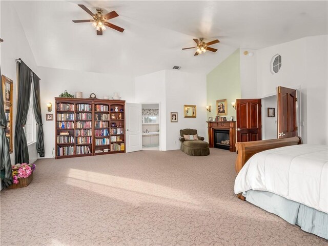 carpeted bedroom with high vaulted ceiling