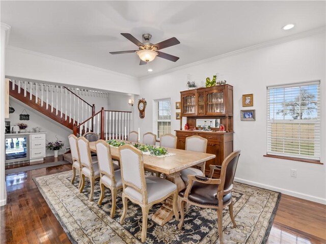 dining space with crown molding, ceiling fan, and dark wood-type flooring