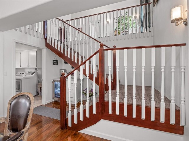 stairway featuring hardwood / wood-style flooring and washer and clothes dryer