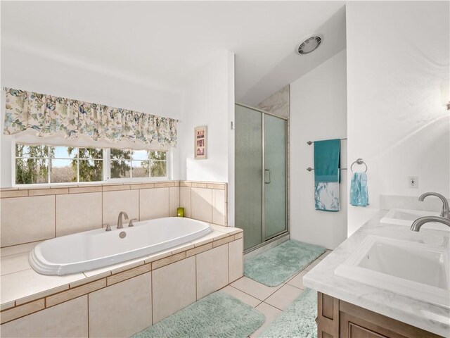 bathroom with independent shower and bath, vanity, and tile patterned flooring