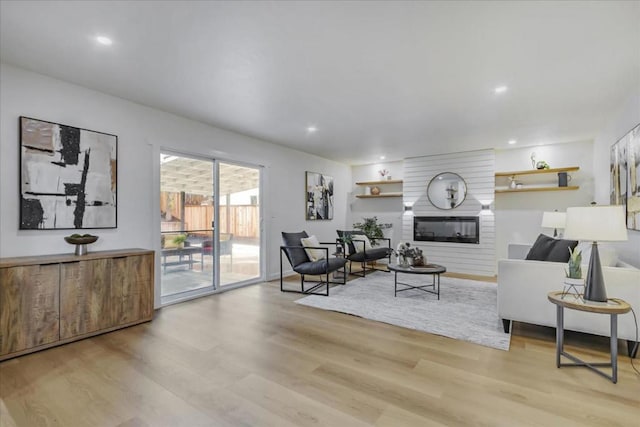 living room with a fireplace and light hardwood / wood-style floors