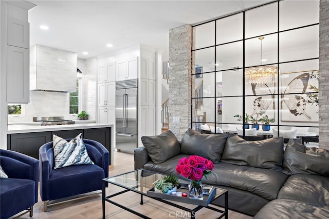 living room with light wood-style floors, stairway, and recessed lighting