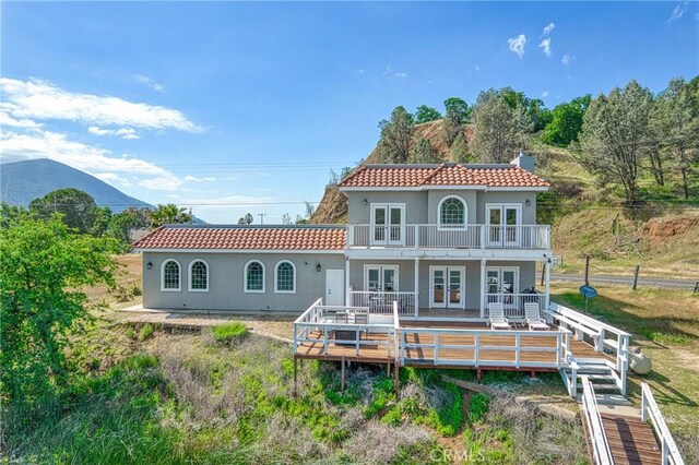 rear view of house featuring french doors and a deck with mountain view