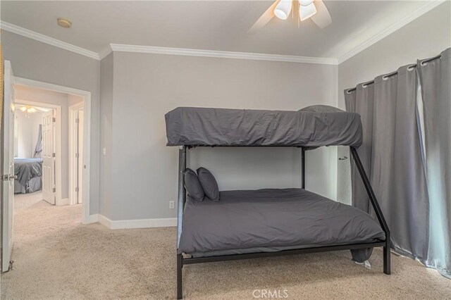 bedroom with ceiling fan, ornamental molding, and light carpet