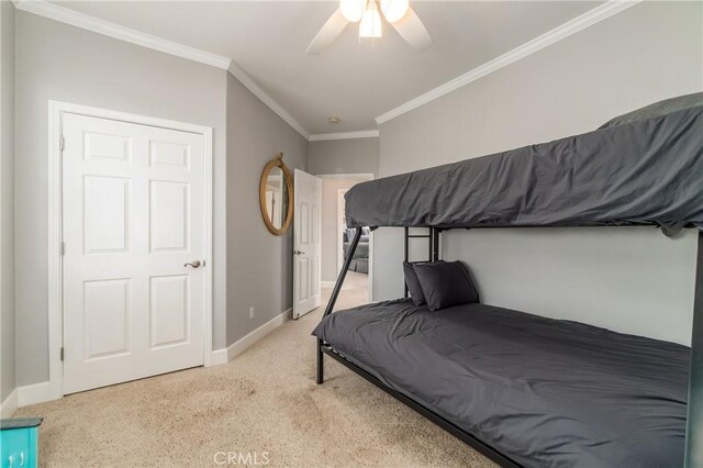 bedroom featuring crown molding, light colored carpet, and ceiling fan