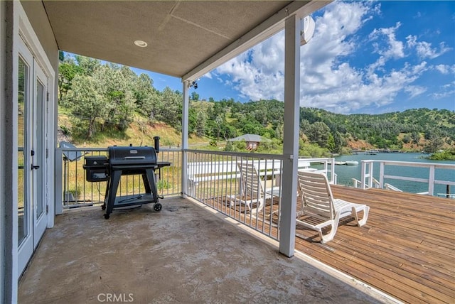 view of patio featuring a water view and a grill