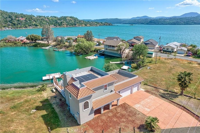 birds eye view of property featuring a water and mountain view