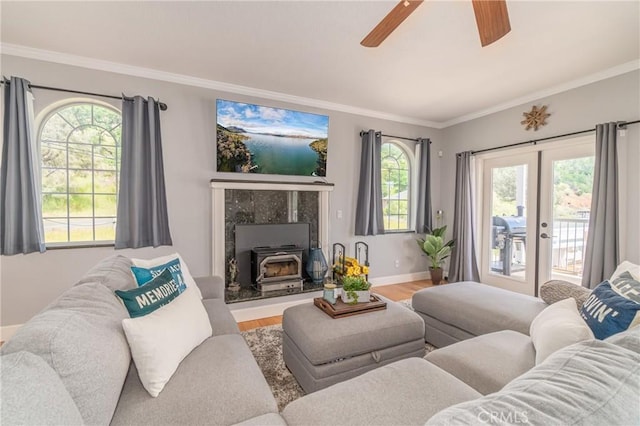 living room featuring hardwood / wood-style flooring, ornamental molding, and a wood stove