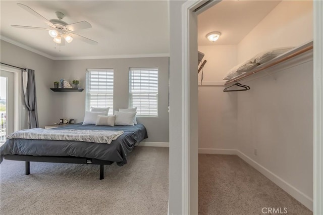 bedroom featuring crown molding, light colored carpet, and ceiling fan