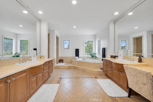 bathroom featuring a bath, a sink, tile patterned floors, and recessed lighting