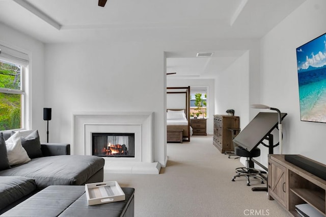 carpeted living room featuring a healthy amount of sunlight and ceiling fan