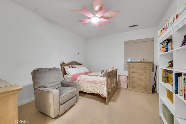 bedroom with ceiling fan and light carpet