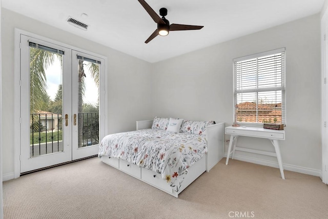 bedroom featuring french doors, light colored carpet, access to exterior, and ceiling fan