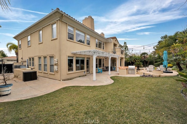 rear view of property featuring a chimney, stucco siding, area for grilling, and a patio