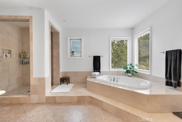 bathroom featuring tile patterned floors, tiled shower, and a bath