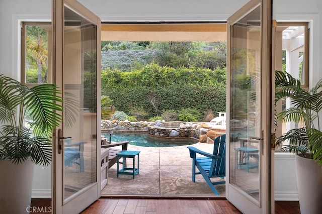 entryway with hardwood / wood-style flooring and french doors