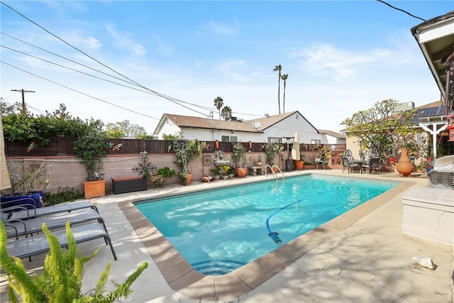 view of swimming pool with a fenced backyard, a fenced in pool, and a patio