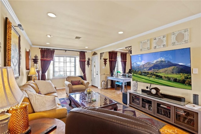 living area with recessed lighting, visible vents, ornamental molding, wood finished floors, and baseboards