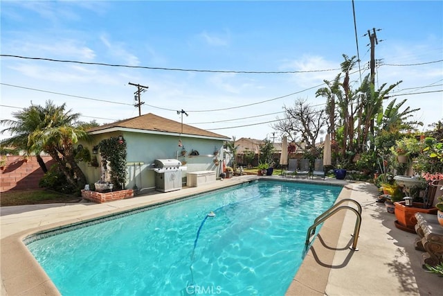 view of pool with a fenced backyard, grilling area, a fenced in pool, and a patio