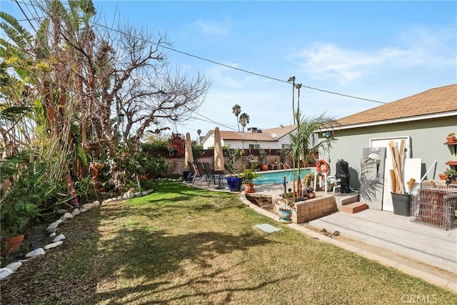 view of yard with a fenced in pool, a fenced backyard, and a patio