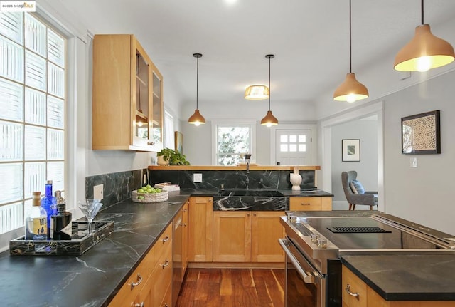 kitchen featuring pendant lighting, stainless steel range with electric stovetop, dark hardwood / wood-style flooring, and sink