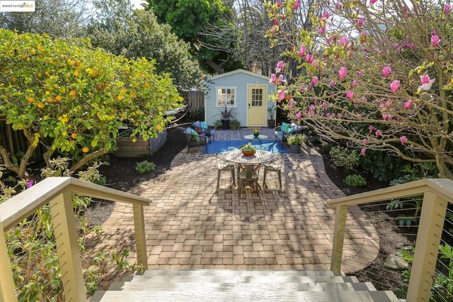 view of patio / terrace with an outbuilding