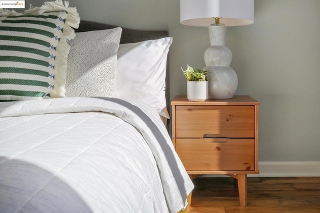 bedroom with dark wood-type flooring