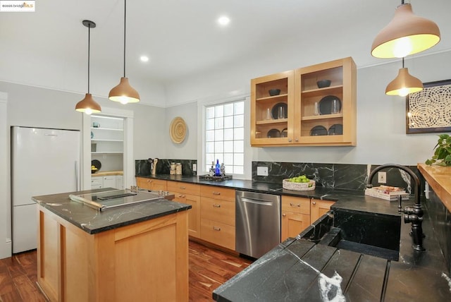 kitchen with pendant lighting, white fridge, a kitchen island, stainless steel dishwasher, and light brown cabinets